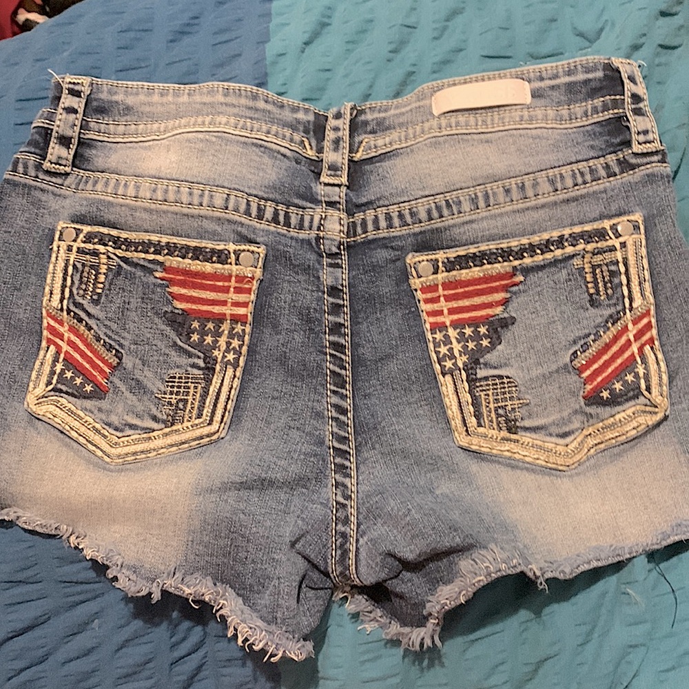 Vigoss Brand Jean shorts size 12, Stars and Stripes on back pockets. Frayed hem